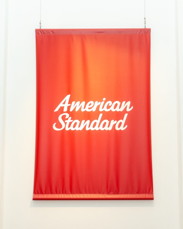 Red American Standard banner on a gallery wall