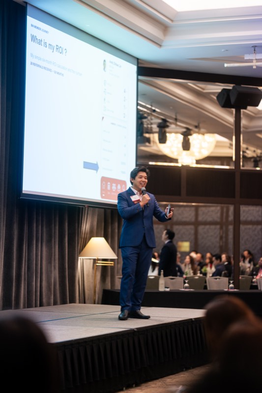 Speaker presenting at a BNI ballroom session