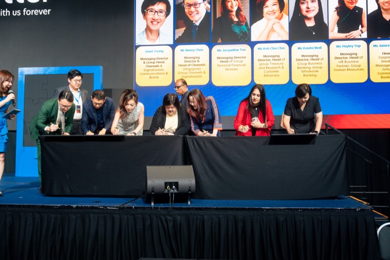 Leadership signing ceremony on stage at UOB's convention